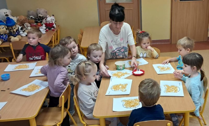 Dzieci wyklejają misie, grupa 3