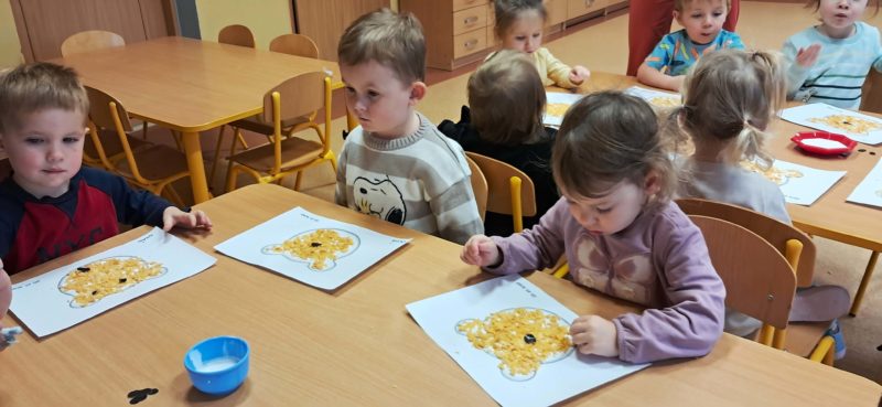 Dzieci wyklejają misie, grupa 3